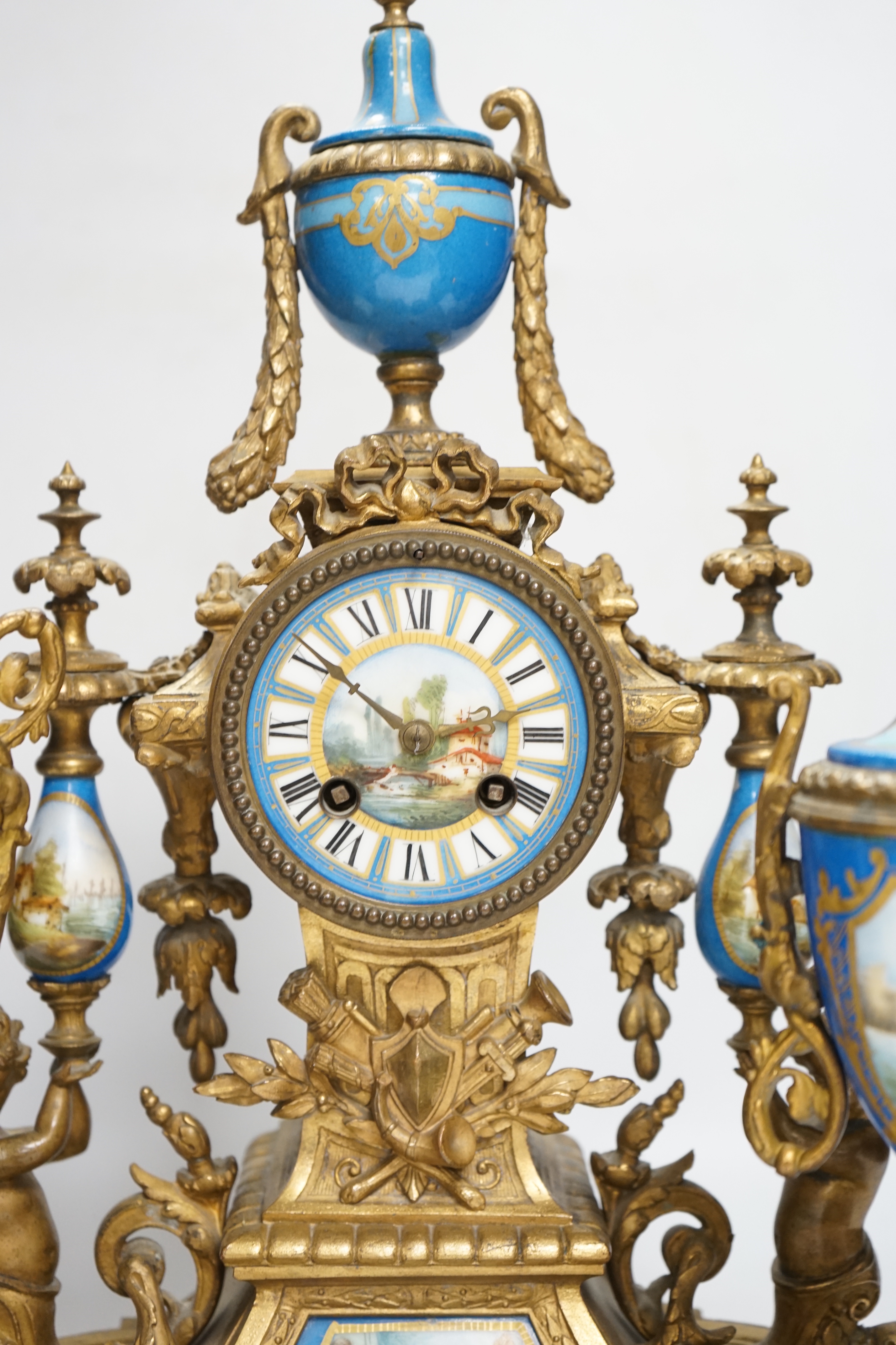 A Sevres style porcelain and gilt metal clock garniture, 44cm high